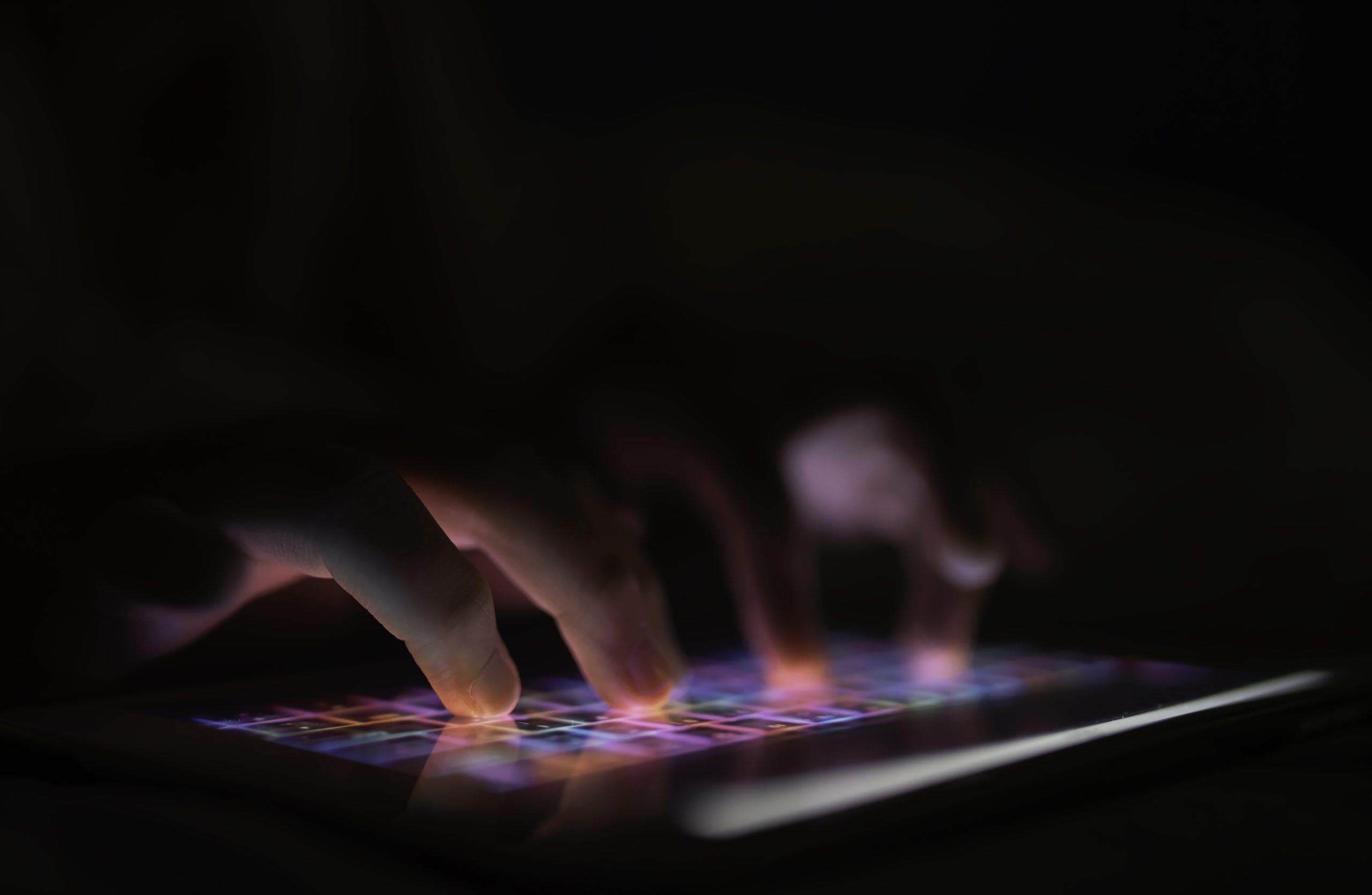 The fingers of small children with tablets, children with a finger display screen Application for children Preschoolers play games,touch devices,Selective focus on the child's finger